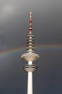 Weather symbol, Telemichel TV tower in front of a dramatic stormy sky with rainbow, Hamburg,