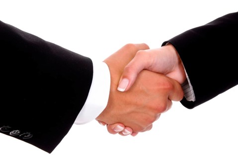 Handshake between man and woman, greeting, signing a contract, studio