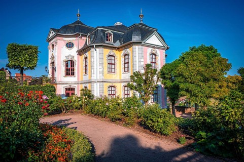 The beautiful rococo castle of the Dornburg Castles with lush gardens and well-tended shrubs under