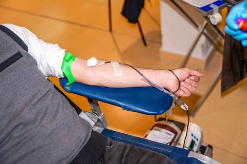 Top view close-up of a man resting while donating blood in a center