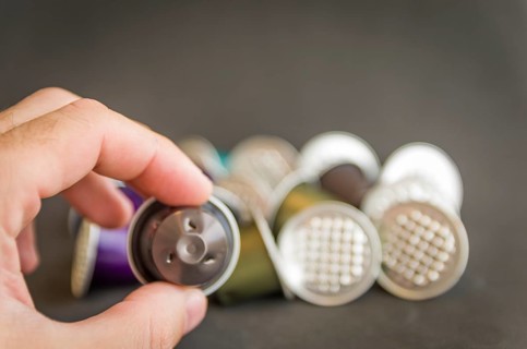 Colorful espresso coffee capsules used on black background, recycling, environment