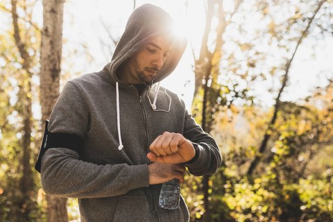 Sportsman checking his watch before starting run