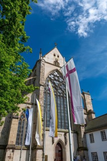Church flags flying in front of Altenberg Cathedral (also known as Bergischer Dom), former