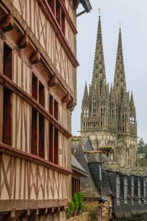 Towers of Saint-Corentin Cathedral, half-timbered house, slate-roofed house in Rue du Lycee,
