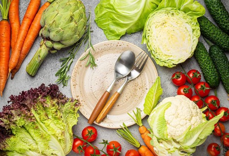 Assorted food raw products: vegetables, beef meat, fish salmon and empty plate in centre, light