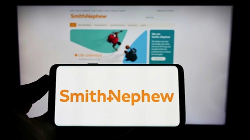Stuttgart, Germany, 05-29-2022: Person holding cellphone with logo of medical equipment company