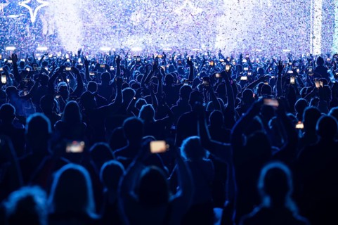 Crowd of people in front of the stage during the concert.