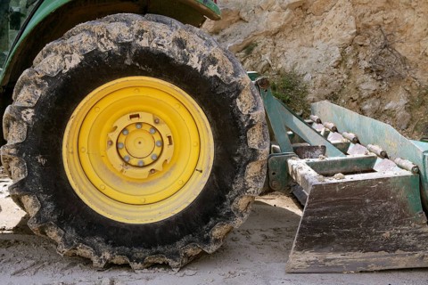 Backhoe bulldozer working hard with stones