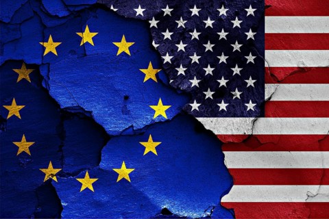 Flags of EU and USA painted on cracked wall