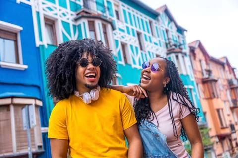 Happy african cool friends with sunglasses and denim casual clothes laughing and chatting in a