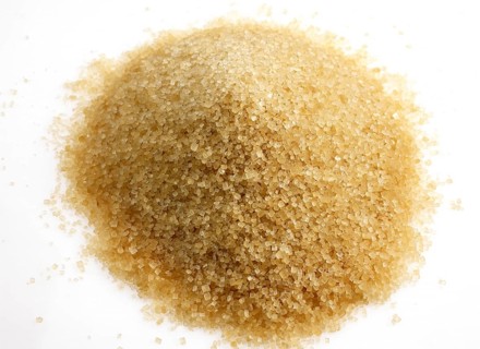 Brown caster sugar against white background