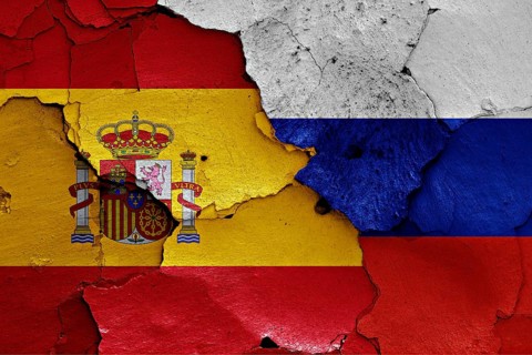 Flags of Spain and Russia painted on cracked wall