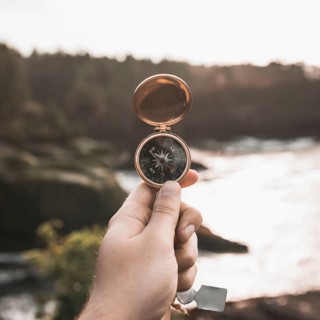 Crop hand with vintage compass