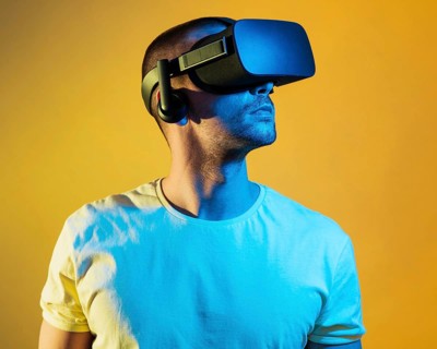 Medium shot man wearing virtual reality gadget