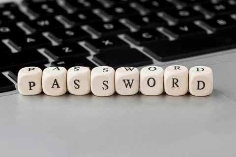 High angle defocused wooden cubes with password laptop