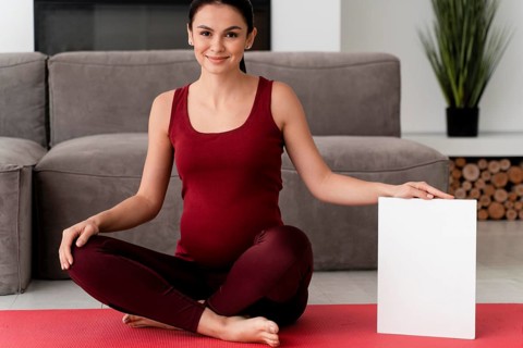 Pregnant woman posing white card