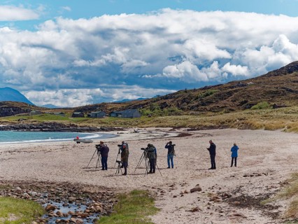 A group of ornithologists watching birds at Mellon Udrigle Beach. Scotland, Great Britain