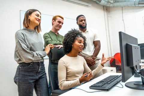 Diverse members of a coworking talking during online meeting together in the office