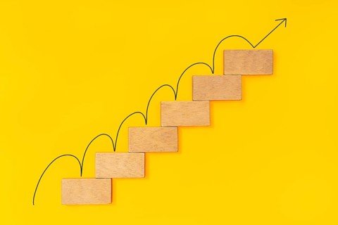 Rising arrow on wooden staircase. Growth concept, Ladder of success in business