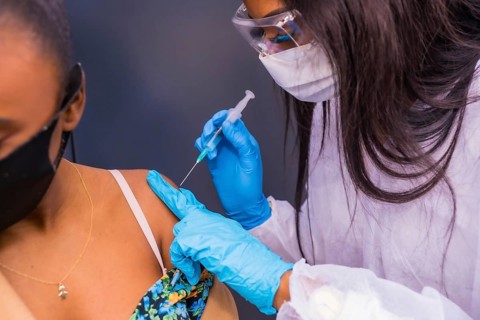 Detail of the vaccination in a black African ethnic girl, immunizes the population, people at risk,
