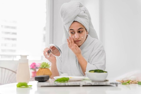 Front view woman applying face cream