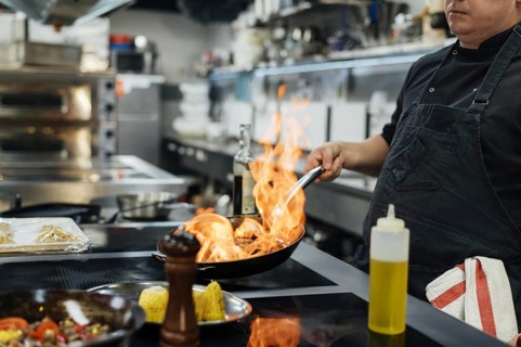 Side view male chef flambeing dish. Resolution and high quality beautiful photo