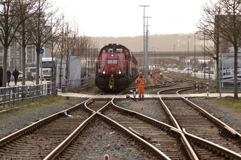 Symbolic image logistics, freight transport, railway tracks with locomotive and freight wagons of