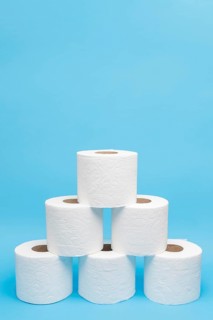 Front view toilet paper rolls stacked pyramid shape