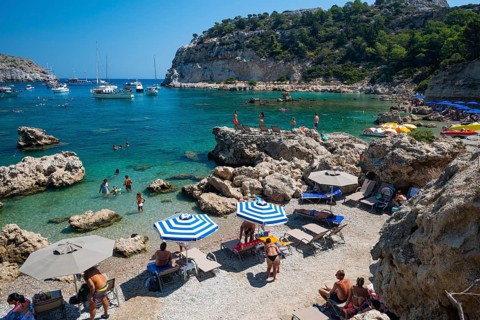 Beach umbrellas and sunbeds, turquoise waters, Anthony Quinn Bay, Faliraki, Rhodes, Dodecanese,
