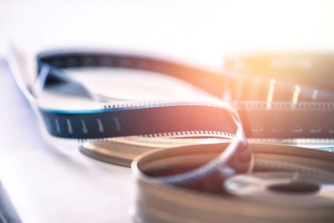 Filmstrip or film reel on a cutting table, vintage film production in cinema