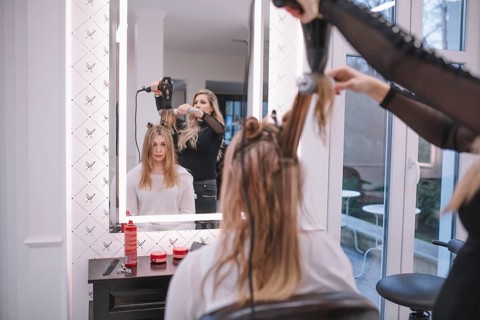 Hairstylist using brush dryer