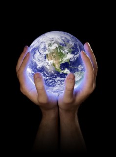 Man holding a glowing planet earth in his hands. Earth image provided by NASA