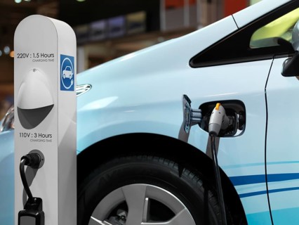 Electric car recharging batteries at a charging station