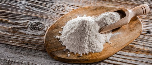 Wheat flour on the wooden cutting board