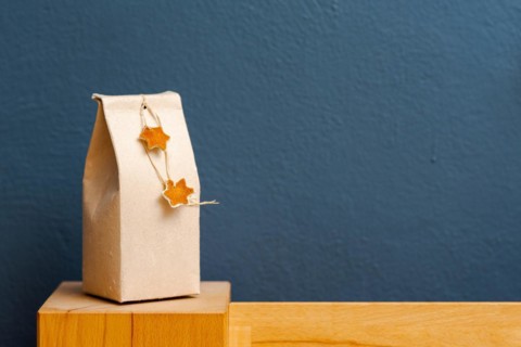 Selfmade gift box out of old beverage carton decorated with star shaped cut out dried roange peel