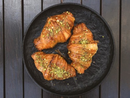 High angle view of three croissants with pistachios on top of them