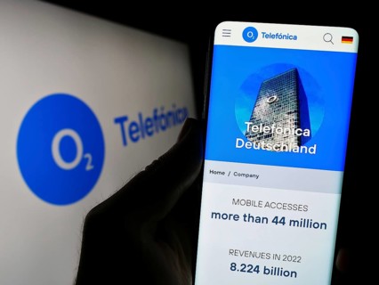 Stuttgart, Germany, 08-21-2023: Person holding cellphone with webpage of company Telefonica