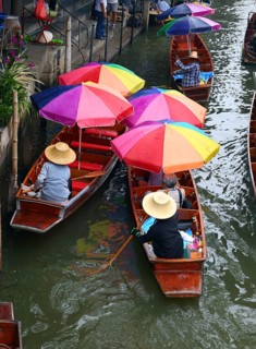 Boats with umbrella on floating market Damnoen Saduak in Bangkok, Thailand, Asia
