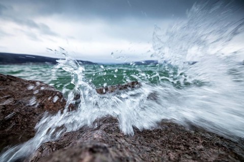 Stormy waves crash against rocks and create impressive splashing water, harbour, Mittelzell,