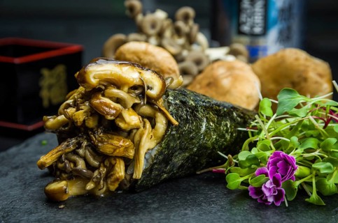 Sushi. Traditional Japanese cuisine, Temaki premium mushrooms, shitake, shimeji, decorated in an
