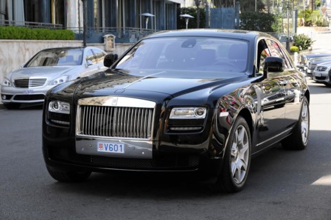 Rolls Royce Ghost at the casino, Monte Carlo, A black Rolls-Royce driving on the road in sunny
