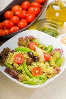 Fresh healthy homemade italian fusilli pasta salad with parmesan cheese, pachino cherry tomatoes,