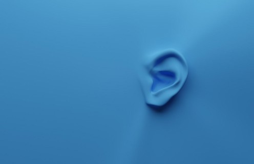 3d rendering of an ear on a blue background with space for your text or image, health care or