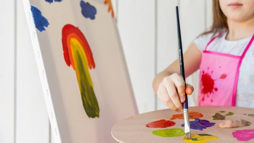 Close up girl painting with paint brush canvas