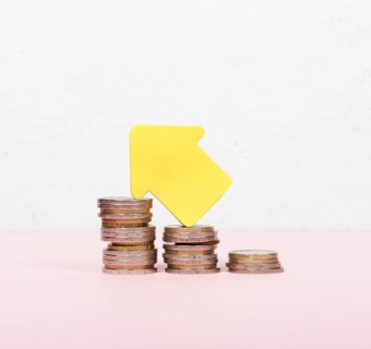 Pile coins arrow pointing up
