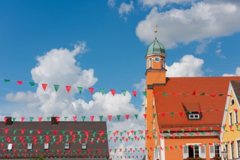 Mainburg in Lower Bavaria, market square with town hall in imperial weather in summer, decorated