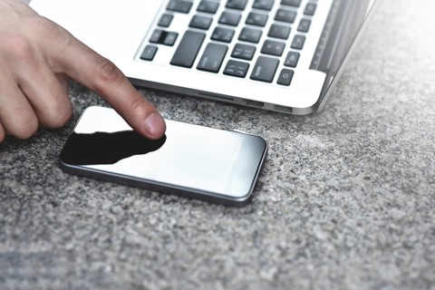 Cropped image of young woman downloading applications and multimedia programs by mobile smartphone,
