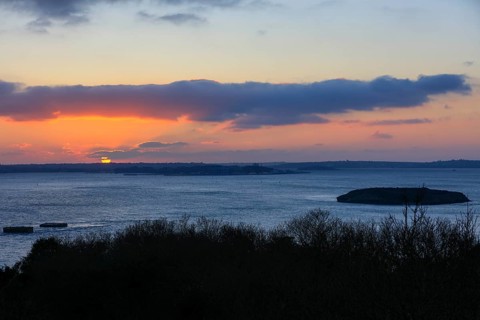 View at sunset from the Pointe de l'Armorique over the bay Rade de Brest with the small island Ile