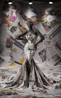 Fashion model poses in a newspaper-crafted dress with a monochrome newspaper background, AI
