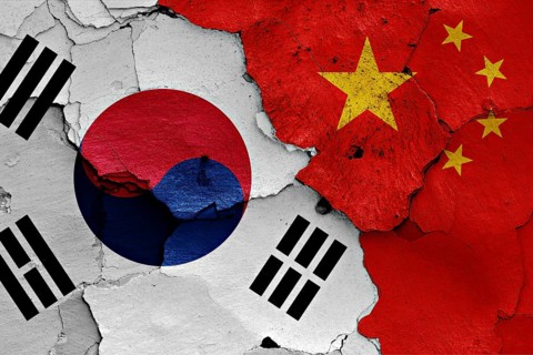 Flag of South Korea and China painted on cracked wall